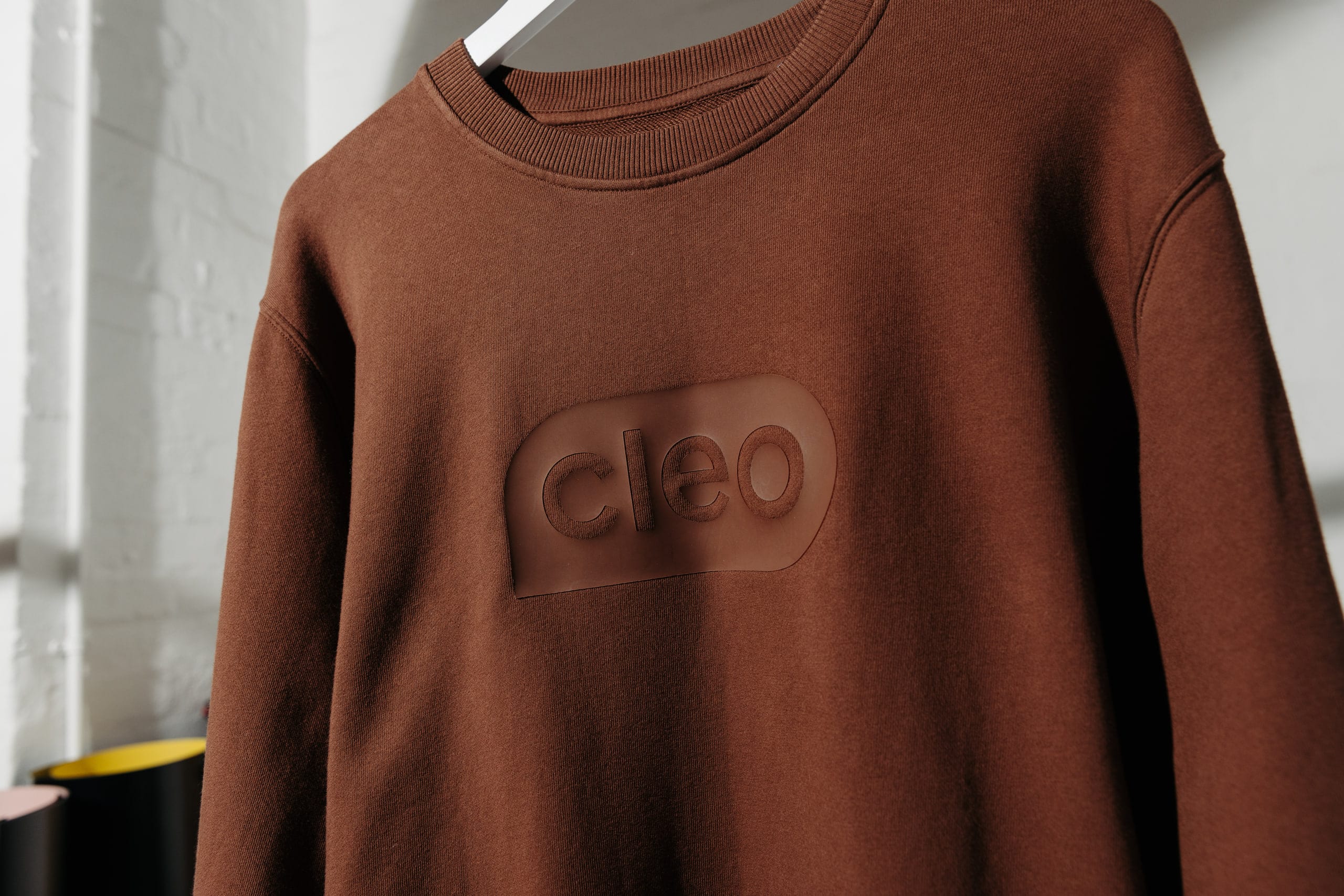 A rust-coloured Cleo sweatshirt with a tonal embroidered chest patch