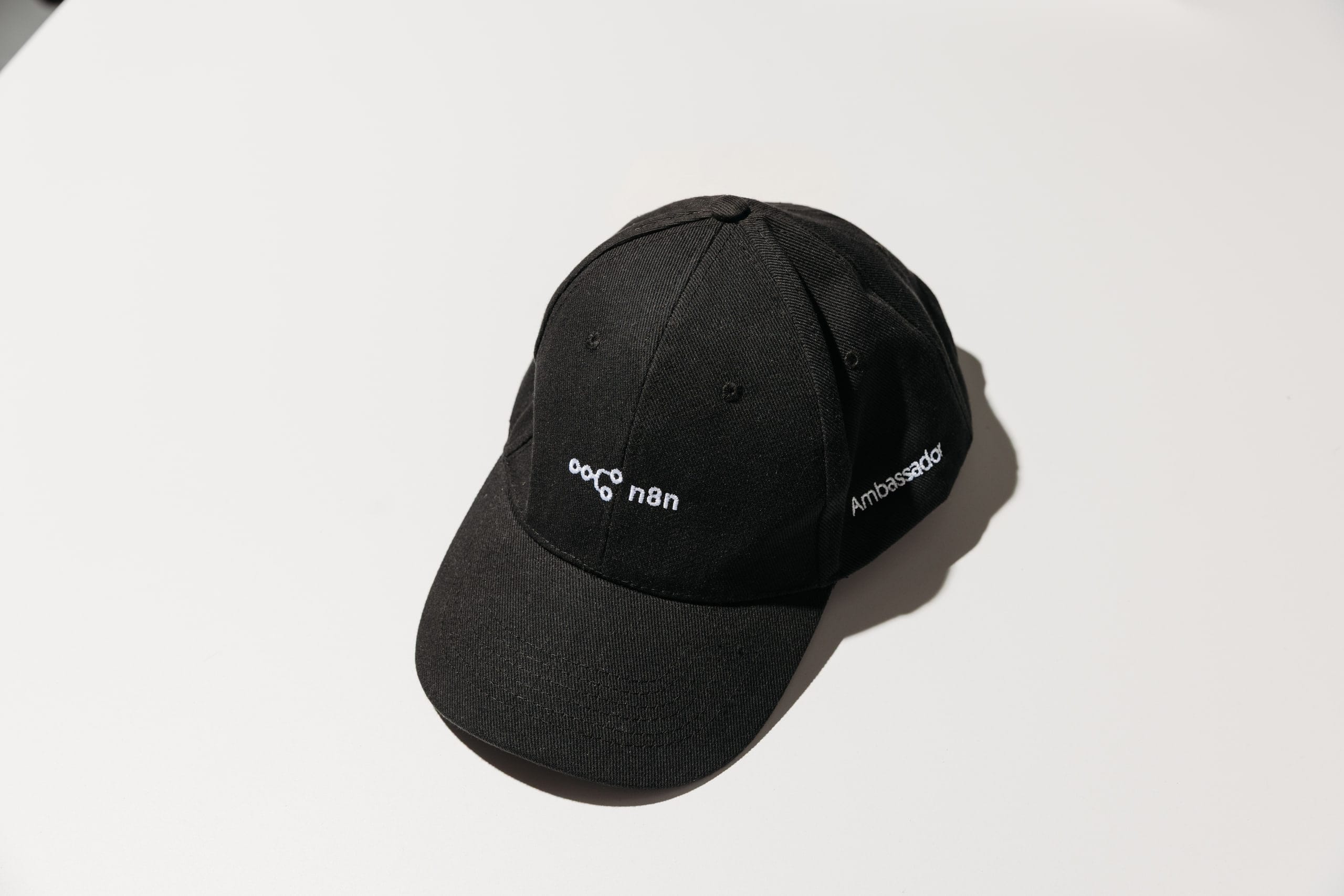 A black n8n Ambassador cap with white embroidery